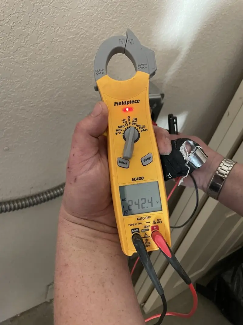 Voltage testing with clamp meter during Recessed Lighting Installation in Norton